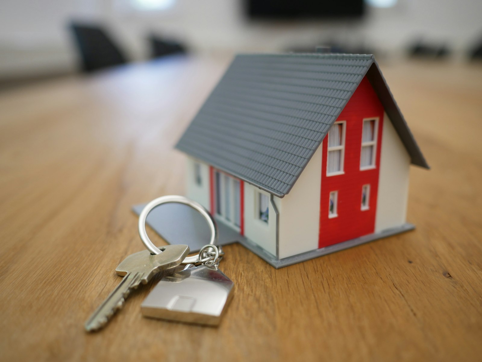A set of keys and a house key fob resting on a desk, representing trusted advocacy for the buyer.