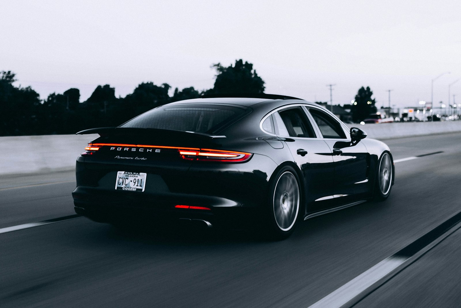 A used car driving down a road at dusk, illustrating how good cars and lemons can look the same.